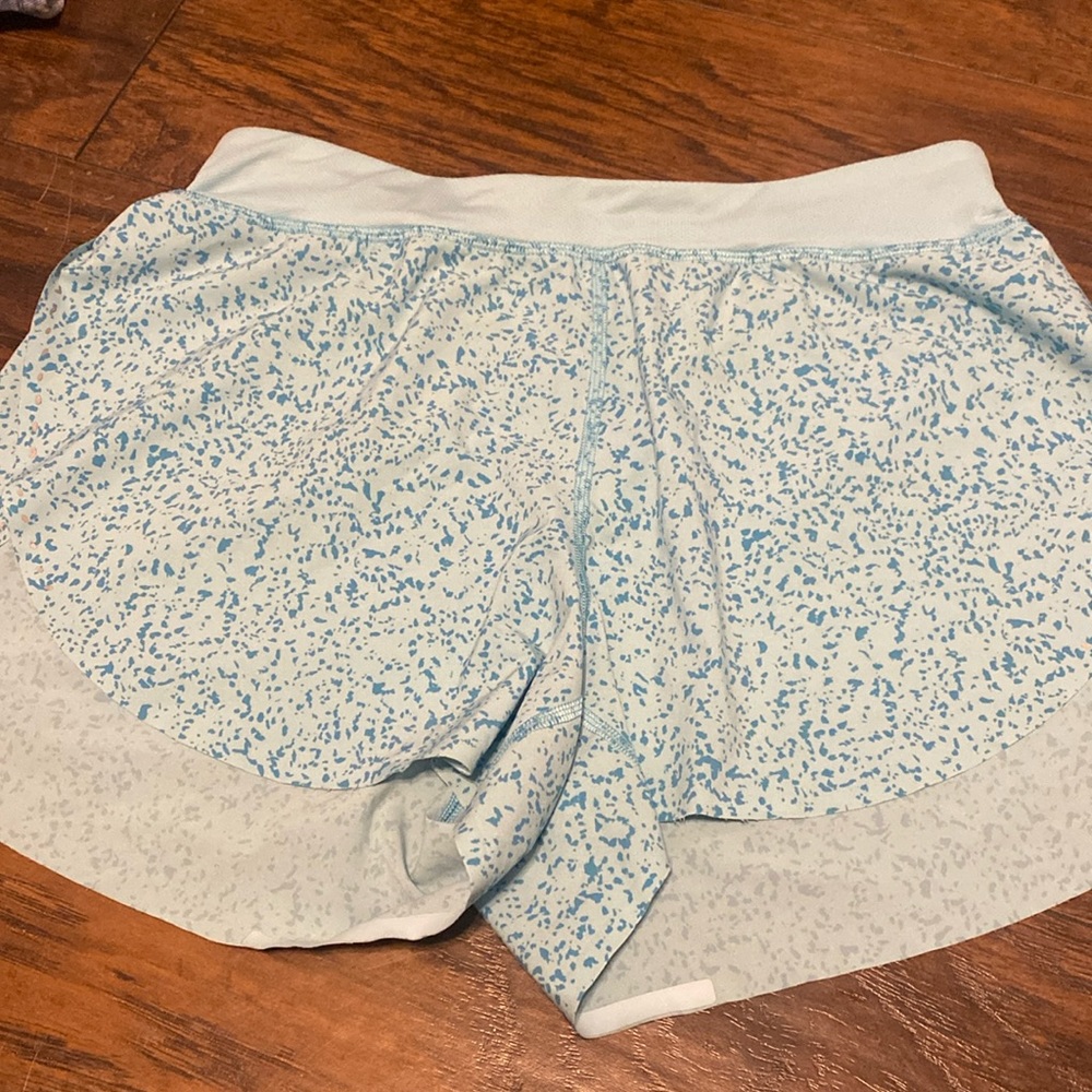 Light blue shorts with dark blue specks on it